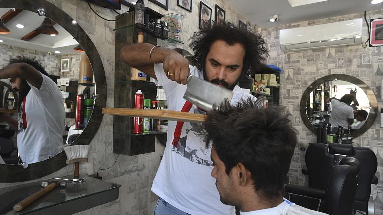 Barber offers hair-raising cuts with cleavers and blowtorches