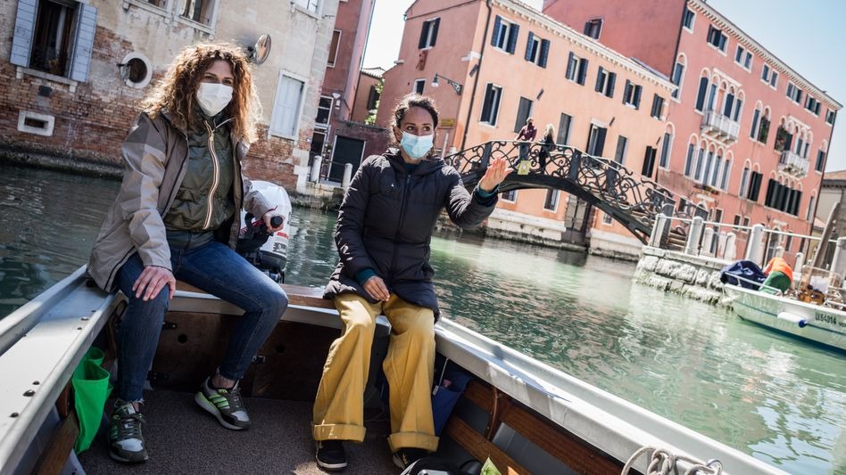 Boating instructor Marta Canino steers her way through the canals of Venice with her student Sara.