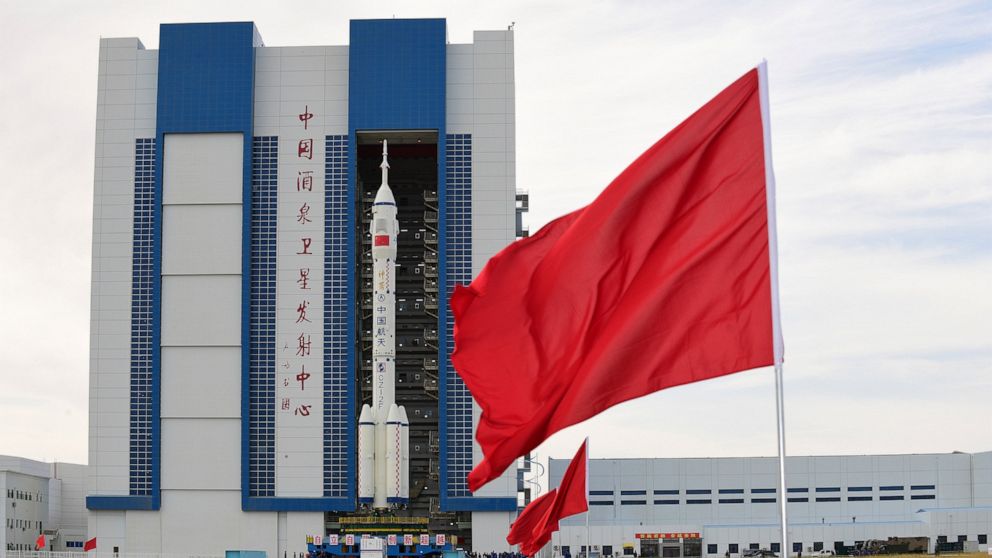In this photo released by Xinhua News Agency, the Shenzhou-12 manned spaceship with its Long March-2F carrier rocket is being transferred to the launching area of Jiuquan Satellite Launch Center in northwestern China's Gansu province, on Wednesday, June 9, 2021. A three-man crew of astronauts will blast off in June for a three-month mission on China's new space station, according to a space official who was the country's first astronaut in orbit in May. (Wang Jiangbo/Xinhua via AP)