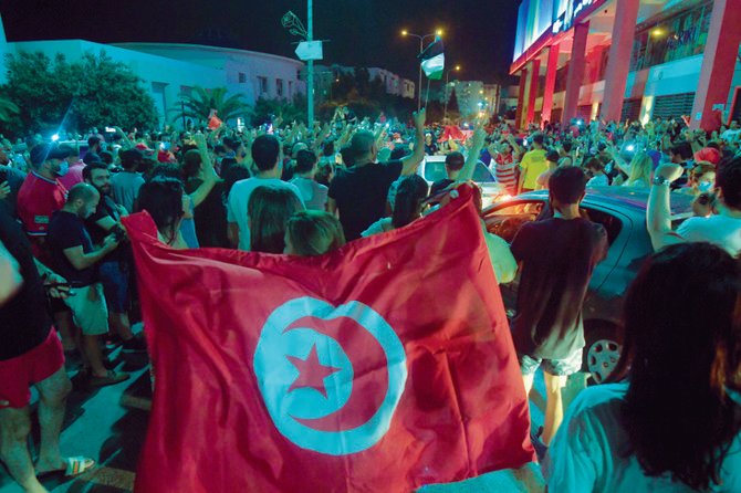 Tunisians celebrated on July 25 after President Kais Saied announced the dismissal of the country’s prime minister following nationwide protests. (AFP)