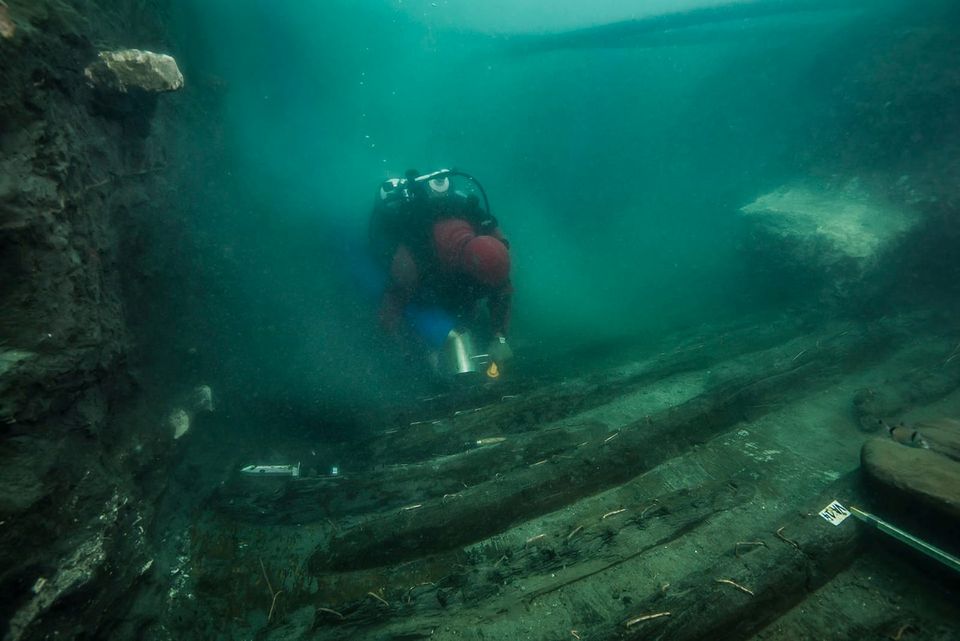 A diver examines the remains of an ancient military vessel discovered in the Mediterranean sunken city of Thonis-Heracleion off the coast of Alexandria, Egypt, in this handout image released on July 19, 2021. The Egyptian Ministry of Antiquities/Handout via REUTERS