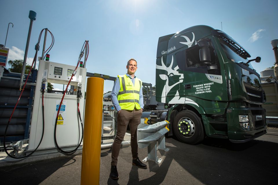 Stuart Watts, a director of Glenfiddich parent company William Grant & Sons, stands by a fuelling station next to their truck, that runs on whiskey-by-product based biogas, in Dufftown, Scotland, Britain in this undated handout obtained July 26, 2021. Courtesy of William Grant & Sons/Handout via REUTERS