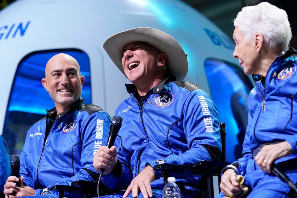 Jeff Bezos, center, with his brother, Mark Bezos, left, and Wally Funk, an aviator who became the oldest person to travel to space, after their Blue Origin flight on Tuesday in Van Horn, Texas.Credit...Tony Gutierrez/Associated Press