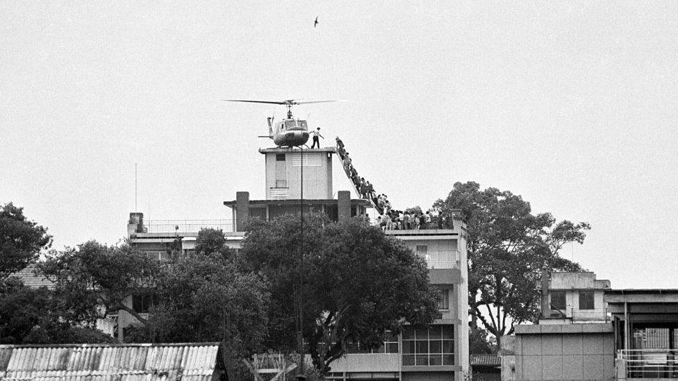 In the iconic photo from 1975, people are seen boarding a helicopter on the roof of the CIA station in Saigon