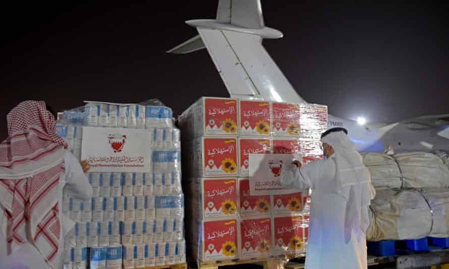 Volunteers label a shipment of humanitarian aid to be sent to Afghanistan at Bahrain international airport. There are hopes Kabul airport will reopen soon. Photograph: Mazen Mahdi/AFP/Getty Images