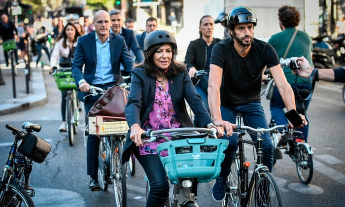 In Paris Mayor Anne Hidalgo, centre, is putting bikes at the centre of her transport policy. Photograph: Stéphane de Sakutin/AFP/Getty Images