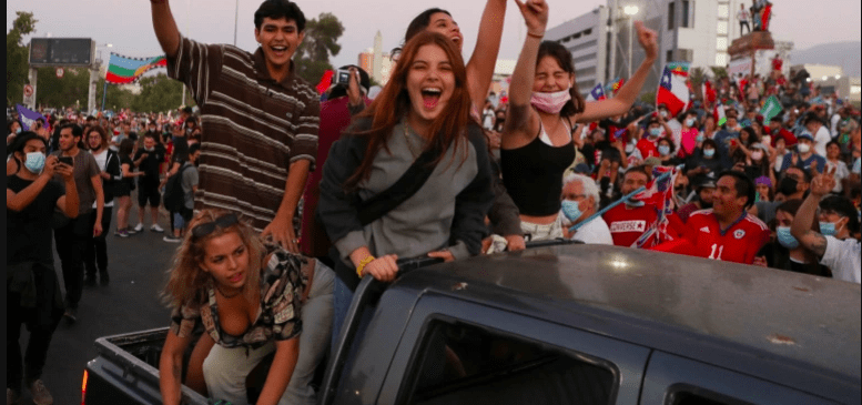 Supporters of Chilean presidential candidate Gabriel Boric ride on the back of a truck as they celebrate after their candidate won the presidential election, in Santiago, Chile, December 19, 2021 [Ivan Alvarado/ Reuters]