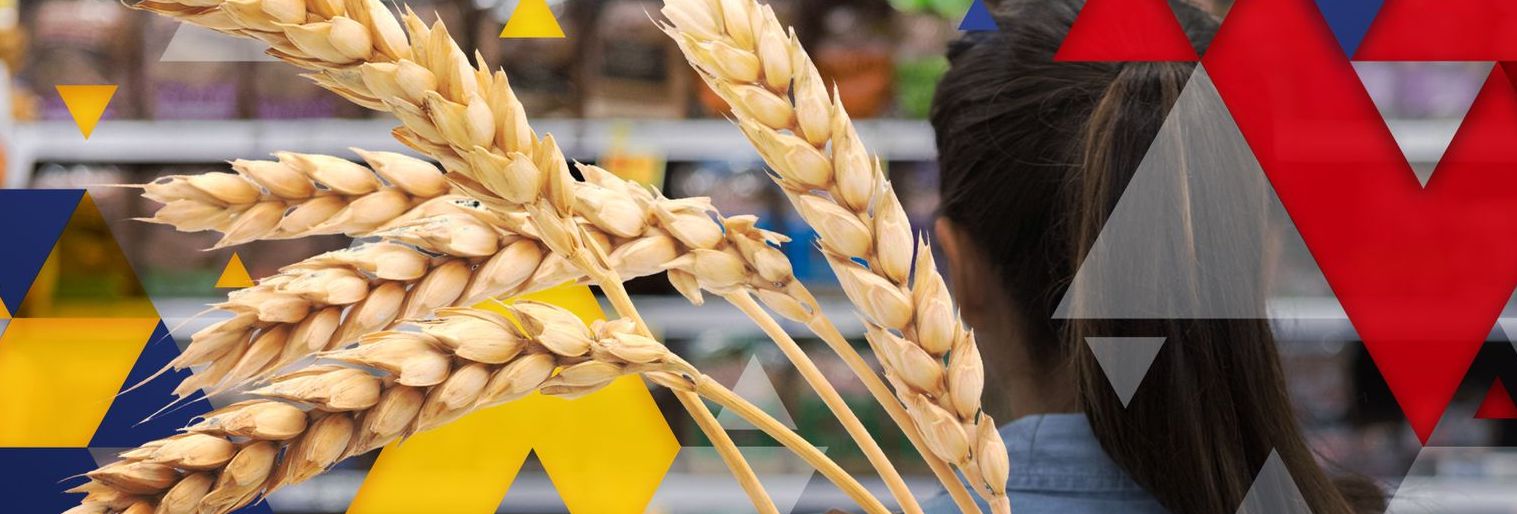 Symbols of Ukraine and Russia against a picture of wheat