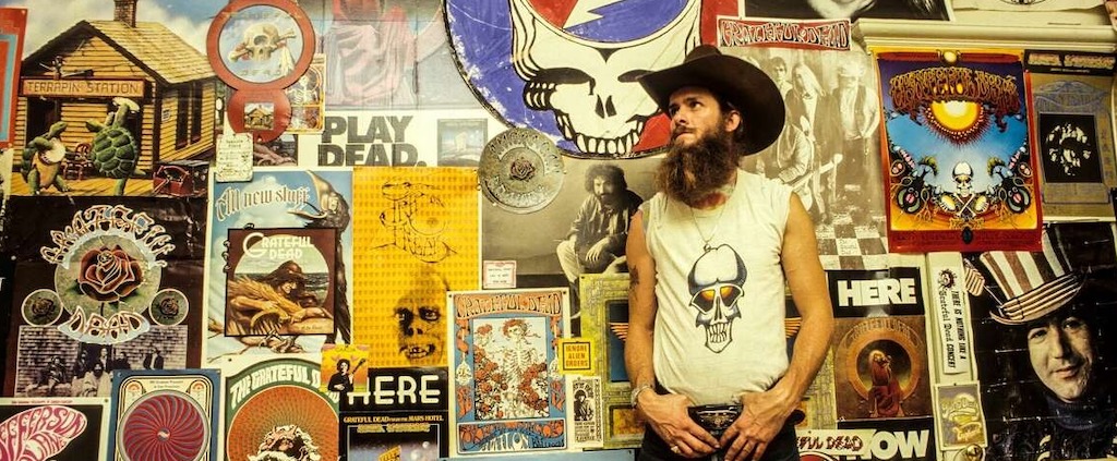 A Deadhead poses in front of Grateful Dead posters at a Haight-Ashbury apartment in January 1980 in San Francisco. Ed Perlstein/Redferns