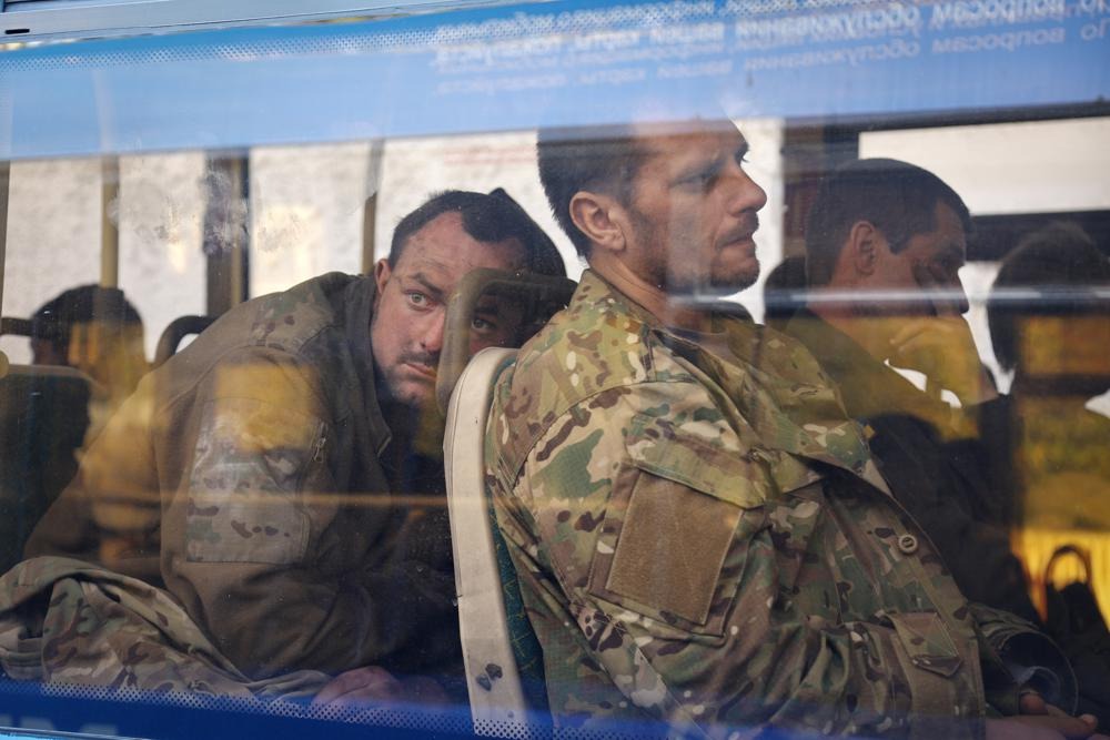 FILE - Ukrainian servicemen sit in a bus after they were evacuated from the besieged Mariupol's Azovstal steel plant (AP Photo/Alexei Alexandrov, File)