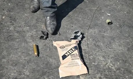 A pro-Russian activist with a shell casing and a US-made meal pack that fell from a Ukrainian army APC in an attack on a roadblock on 3 May in Andreevka, Ukraine. Photograph: Scott Olson/Getty
