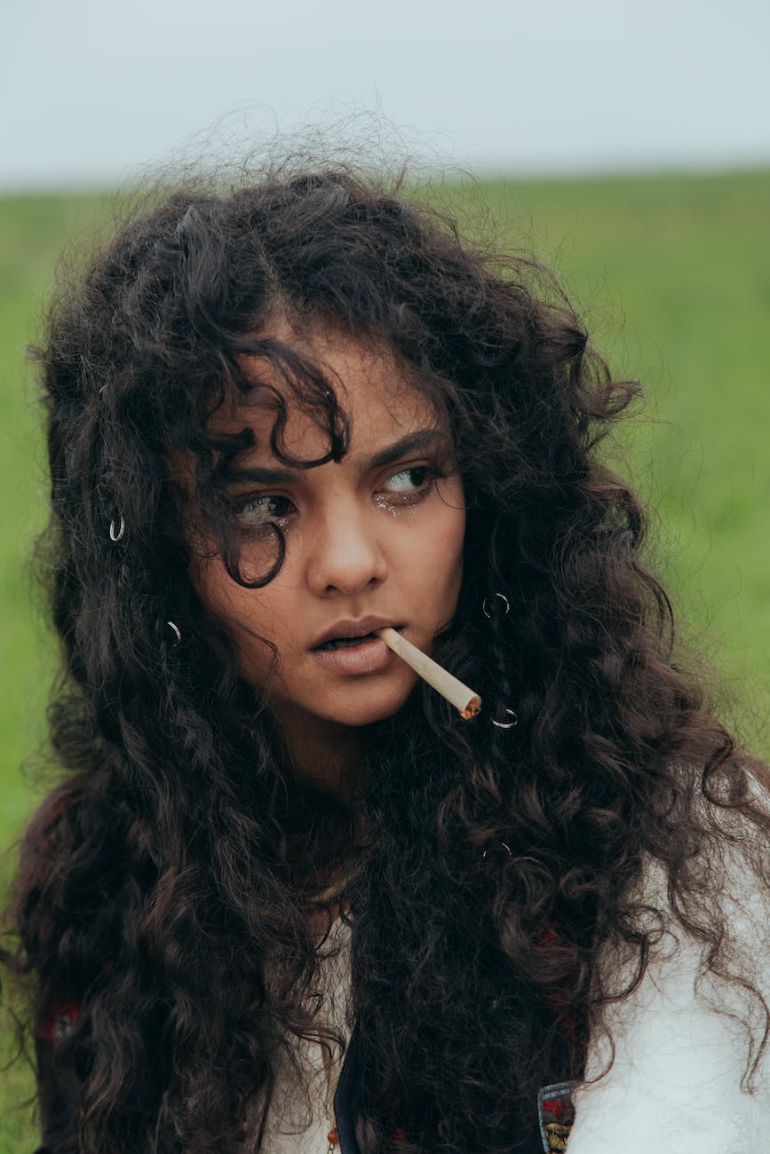 a curly hair woman smoking weed